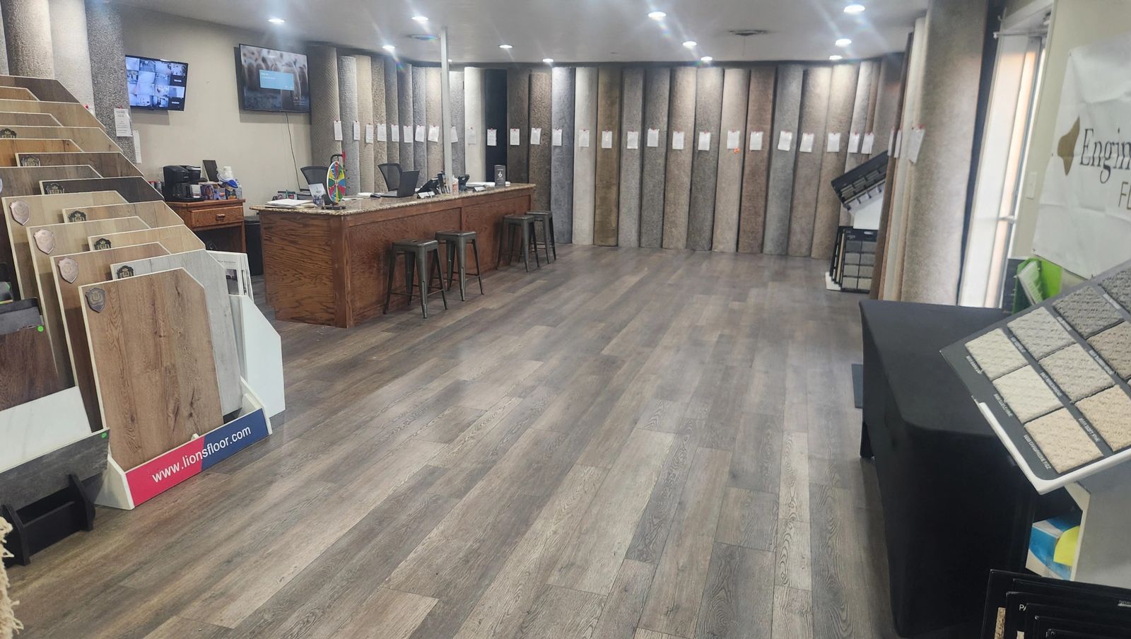 Inside Carpet Depot's showroom in Oklahoma City, with rows of in-stock carpet rolls, flooring sample displays and the sales counter